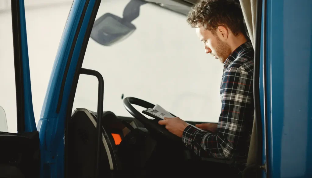 Man in truck filling out check list